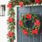 Glitzhome® 9ft. Pre-Lit Greenery Pine Poinsettia and Berries Christmas Garland with LED Lights and Timer